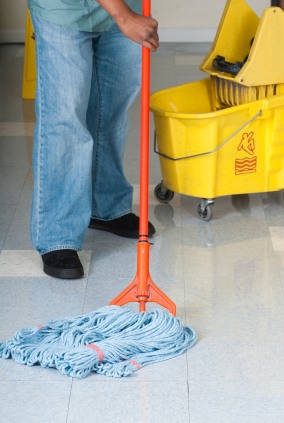 Spot Free Cleaning Services, LLC janitor in Winter Springs, FL mopping floor.